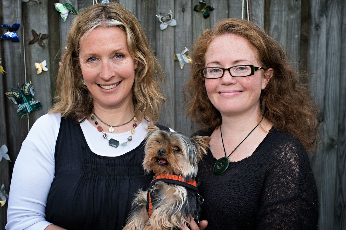 Karen and Laura run the food market and are pictured smiling with a small dog